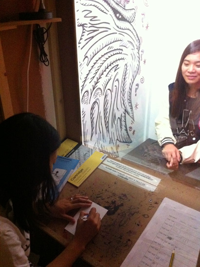 Drawing in the Sketch-O-Mat. Sitters drop a suggested donation of £1 for a 5-minute portrait.